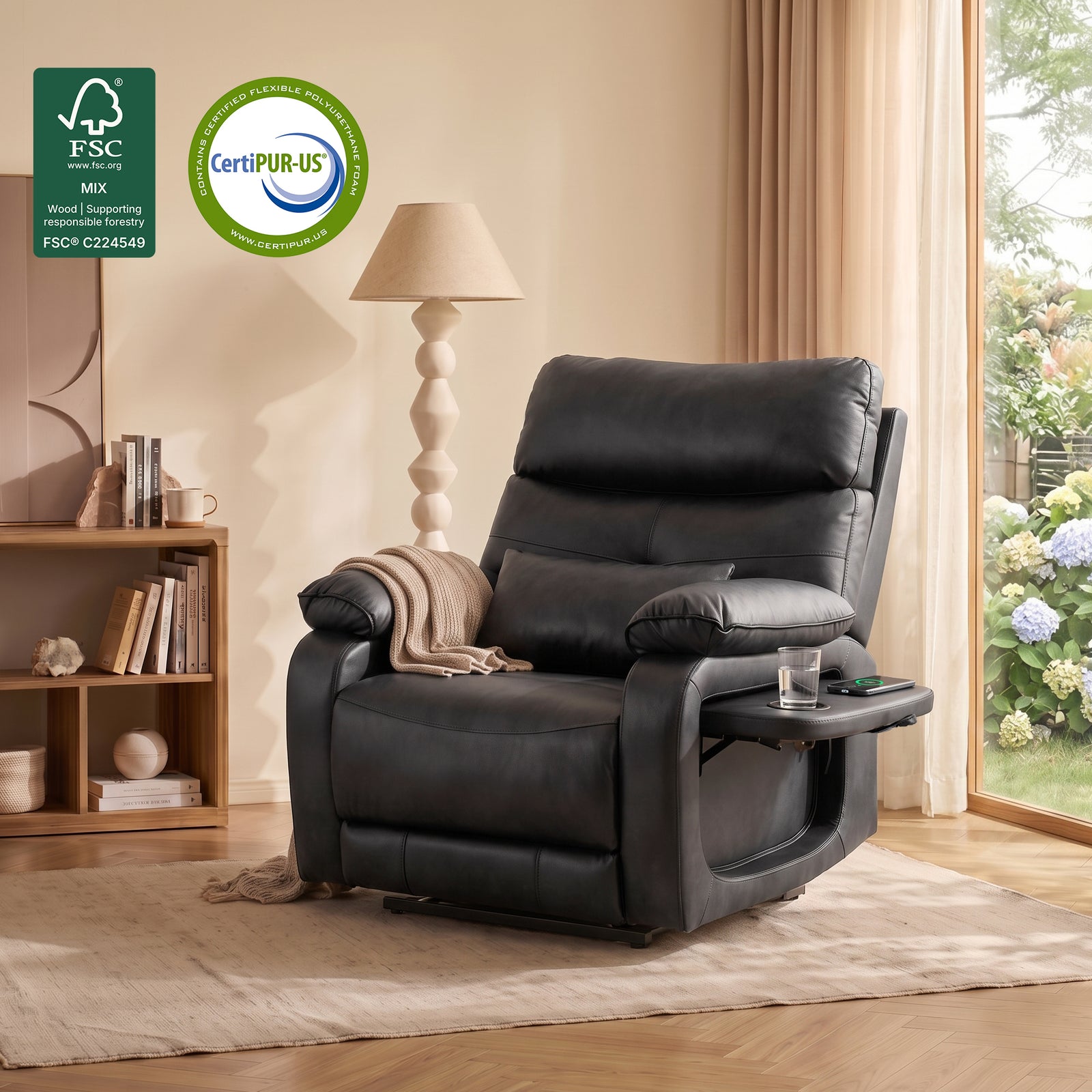 Lifestyle interior photo of black faux leather power lift recliner chair for seniors, foldable side tray with cup holder, draped knit throw blanket, FSC sustainable wood frame and CertiPUR-US certified foam badges at top left, cozy bright living room with wooden bookshelf, floor lamp and garden view window